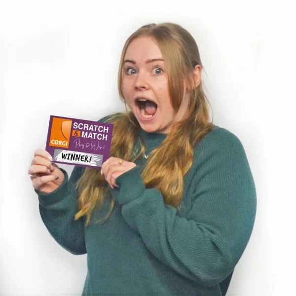 Woman Wins a Scratch Card and looks really happy whilst holding it up to the camera
