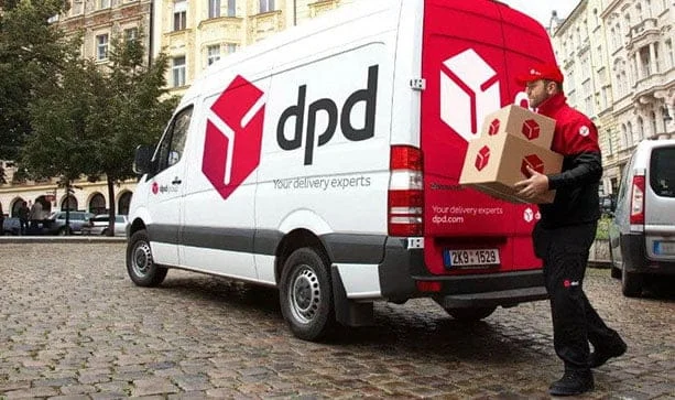 delivery driver delivering a package from his van