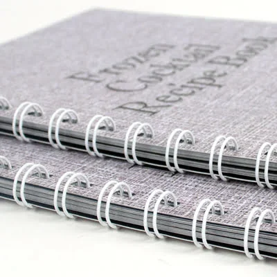 2 wiro-bound notepads stacked one on top of the other