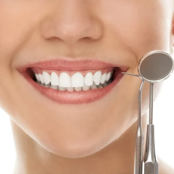 Healthcare Services 2 Close up on woman smiling with dental equipment next to her face